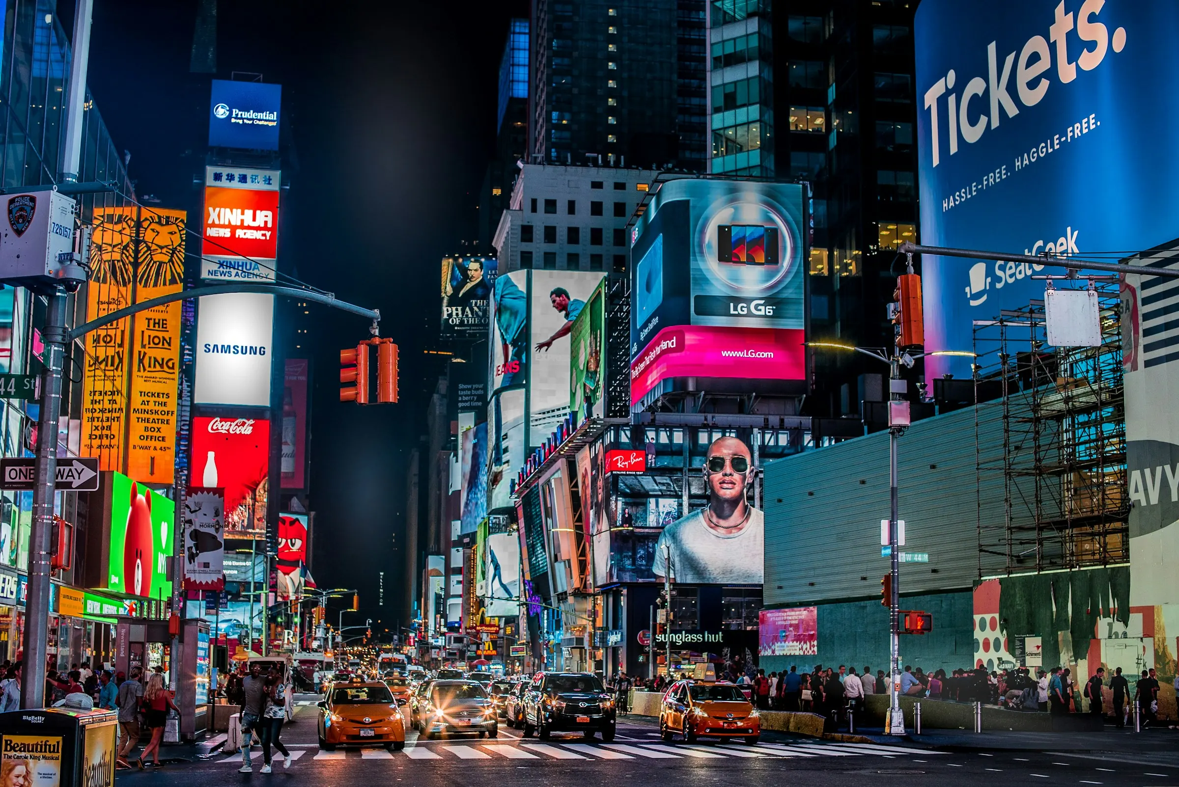 Times Square at night, lit up with campaign billboards